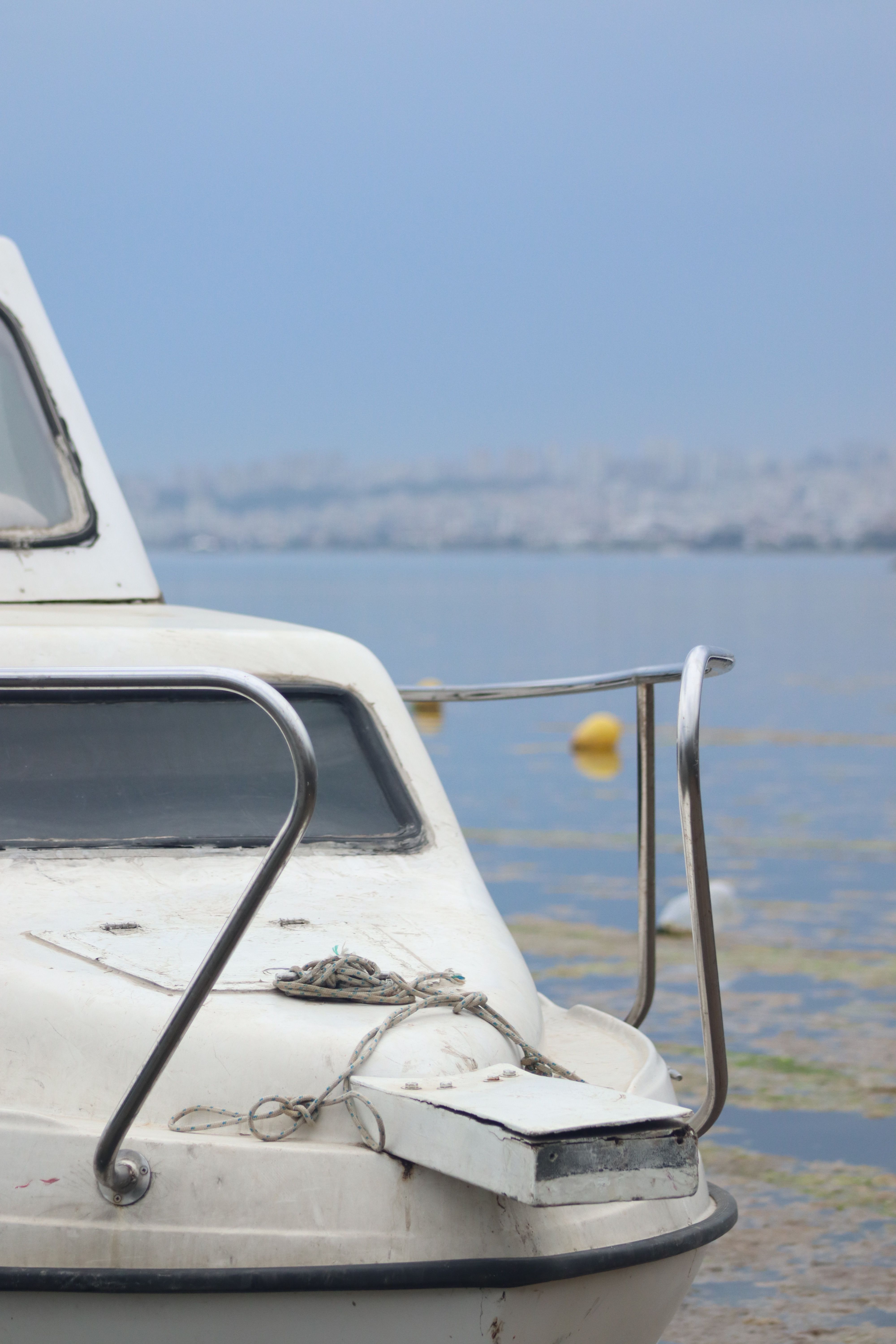 Well-loved boat sitting alongside shore.